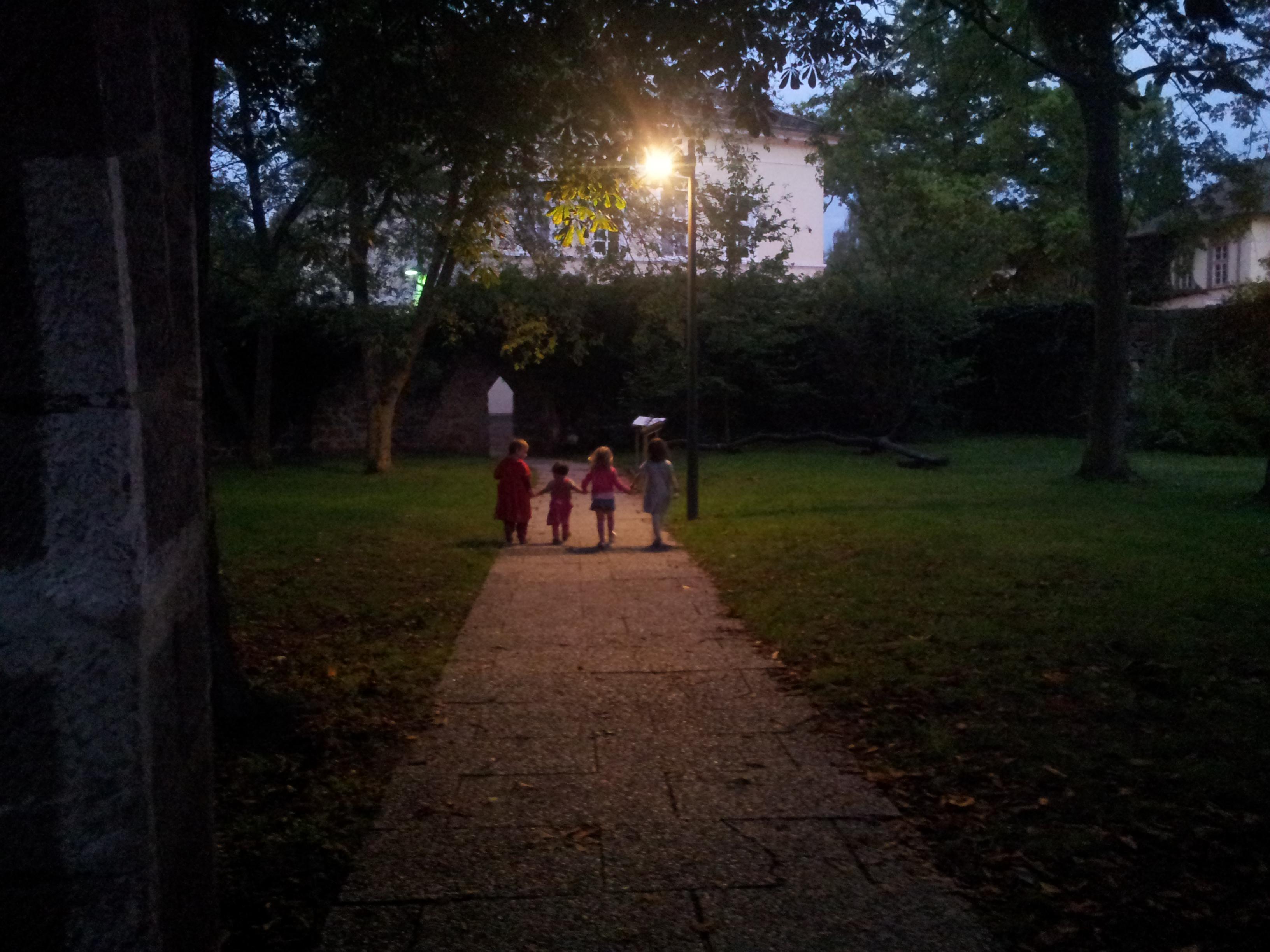 Children walking together in the garden